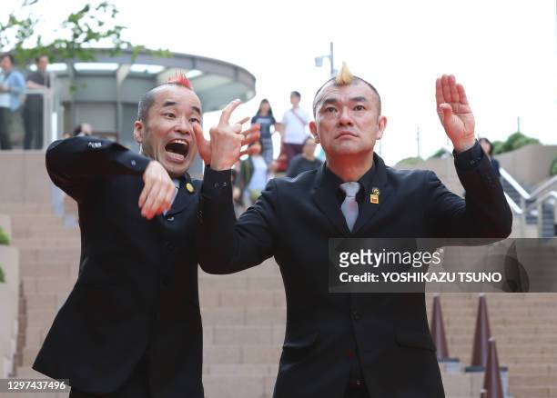 Japanese silent comedy duo "Gamarjobat" members Ketch and Hiro-pon perform at the outside stage of the newly opened Tokyo Midtown Hibiya in Tokyo on...
