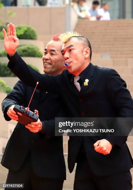 Japanese silent comedy duo "Gamarjobat" members Ketch and Hiro-pon perform at the outside stage of the newly opened Tokyo Midtown Hibiya in Tokyo on...