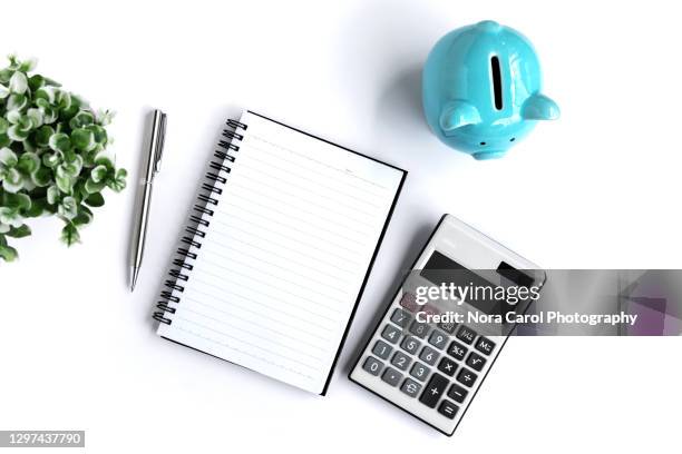 piggy bank, calculator and note pad - calculator top view stock-fotos und bilder