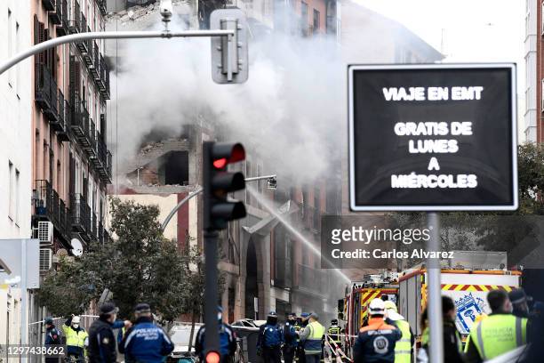 Firefighters put out flames after Six floors collapsed on a building after a large explosion on Toledo Street in central Madrid on January 20, 2021...