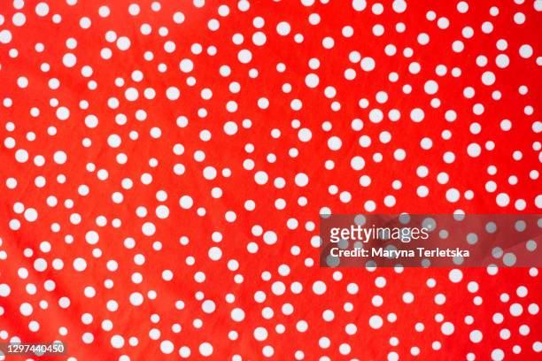 red fabric background with white polka dots. - polka dot stock pictures, royalty-free photos & images