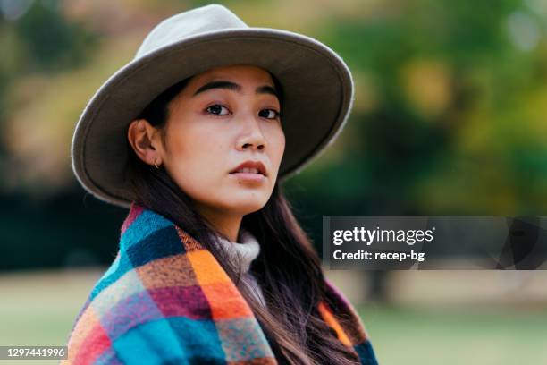 portrait of young fashionable beautiful woman in nature in autumn - orange hat stock pictures, royalty-free photos & images