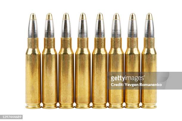 large caliber bullets in a row, isolated on white background - kalashnikov fotografías e imágenes de stock