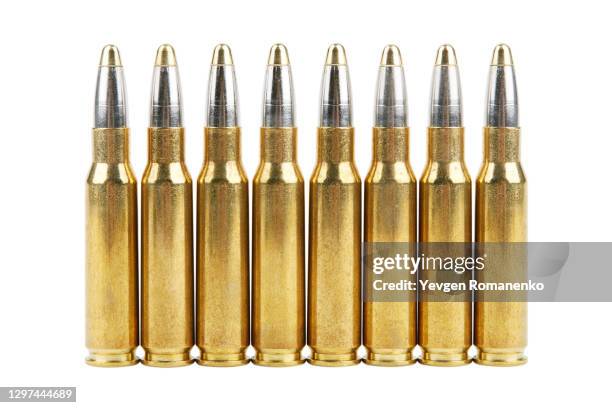 large caliber bullets in a row, isolated on white background - munition stock pictures, royalty-free photos & images