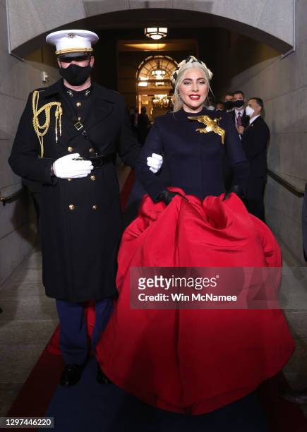 Lady Gaga is escorted by U.S. Marine escort Capt. Evan Campbell to sing the National Anthem at the inauguration of U.S. President-elect Joe Biden on...