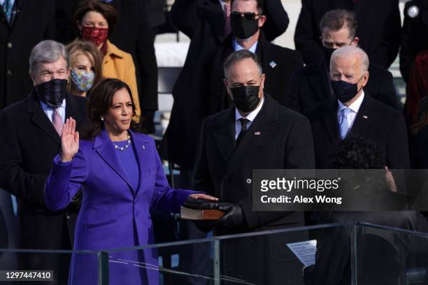 Kamala Harris is sworn in as U.S. Vice President as her husband Doug Emhoff looks on during the inauguration of U.S. President-elect Joe Biden on the...