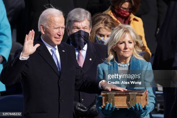 Joe Biden is sworn in as U.S. President as his wife Dr. Jill Biden looks on during his inauguration on the West Front of the U.S. Capitol on January...