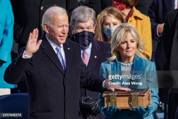 Joe Biden is sworn in as U.S. President as his wife Dr. Jill Biden looks on during his inauguration on the West Front of the U.S. Capitol on January...