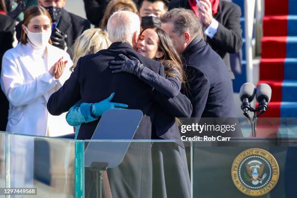 President Joe Biden hugs Jill Biden and daughter Ashley Biden after being sworn in as U.S. President on the West Front of the U.S. Capitol on January...