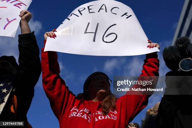 Supporter of former U.S. President Donald Trump hold signs calling for the impeachment of newly sworn in U.S. President Joe Biden during the...