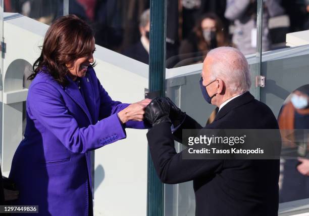 Vice President Kamala Harris celebrates with President-elect Joe Biden after being sworn in during the inauguration on the West Front of the U.S....
