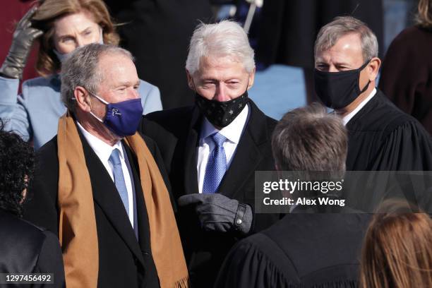 Former U.S. Presidents George W. Bush and Bill Clinton speak with Supreme Court Chief Justice John Roberts and Supreme Court Associate Justice Brett...