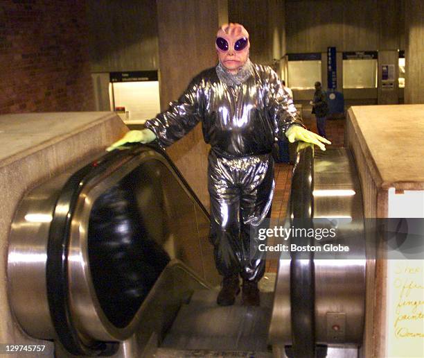 Engineer Harry Tripp, dressed in an alien costume, rides the escalator to the third floor of Boston City Hall to entertain kids at the Haunted...