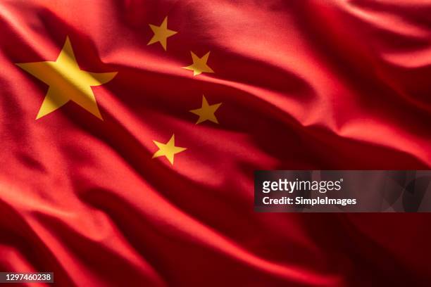 china flag blowing in the wind. - flagge stock-fotos und bilder