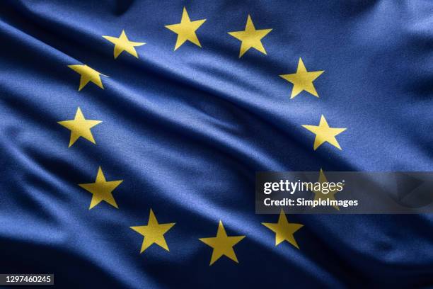 european union flag blowing in the wind. - europees parlement stockfoto's en -beelden