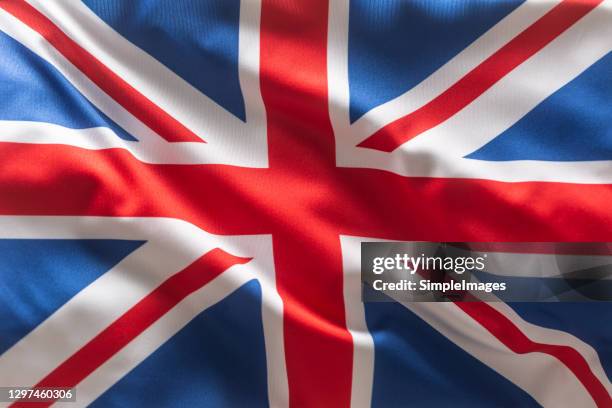 brithish uk flag blowing in the wind. - national colors stock pictures, royalty-free photos & images