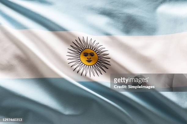 argentina flag blowing in the wind. - bandera argentina fotografías e imágenes de stock
