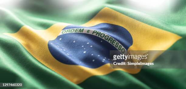 brazilia flag blowing in the wind. - brasilien stock-fotos und bilder