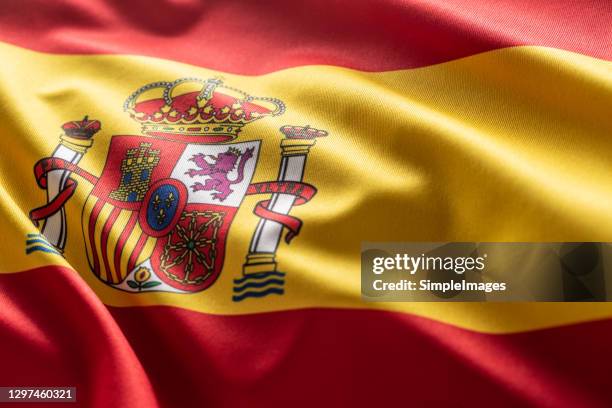 spanish flag blowing in the wind. - spanische flagge stock-fotos und bilder