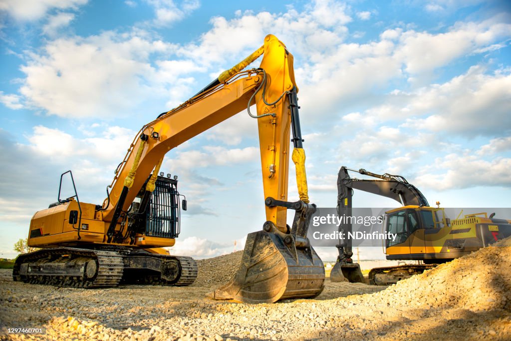 Excavator digs gravel stock photo