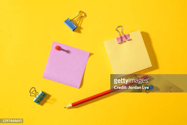 close-up of purple and yellow adhesive note - office supply stock pictures, royalty-free photos & images