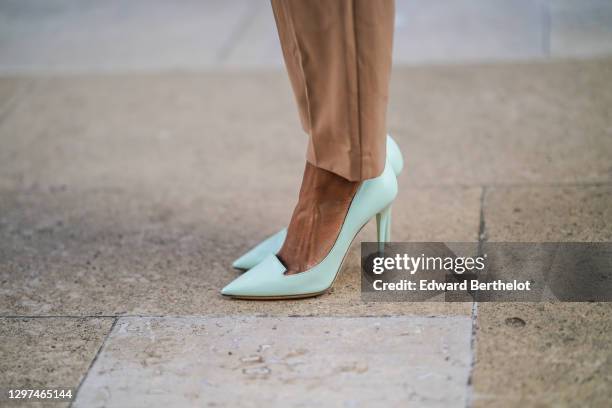 Emilie Joseph wears pale green high heeled pointy shoes/pumps from Jimmy Choo, on January 17, 2021 in Paris, France.