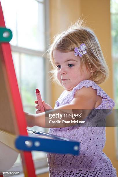 baby drawing on easel - kid holding crayons stock pictures, royalty-free photos & images