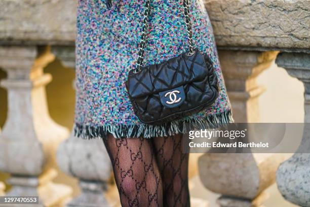 Bianca Derhy wears a multicolor woven fringed dress from Dior, a thin leather belt, black monogram printed tights from Gucci, a black leather quilted...