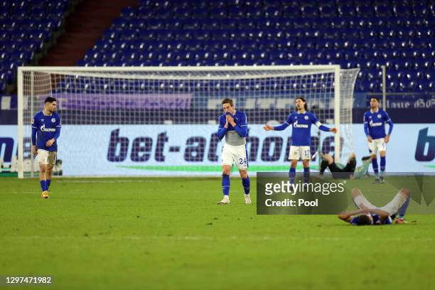 Bastian Oczipka of FC Schalke 04 and teammates react after conceding their second goal during the Bundesliga match between FC Schalke 04 and 1. FC...