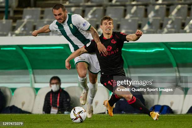 Thierry Moutinho of Cordoba CF competes for the ball with Aihen Munoz of Real Sociedad during the Copa del Rey Third Round match between Cordoba CF...