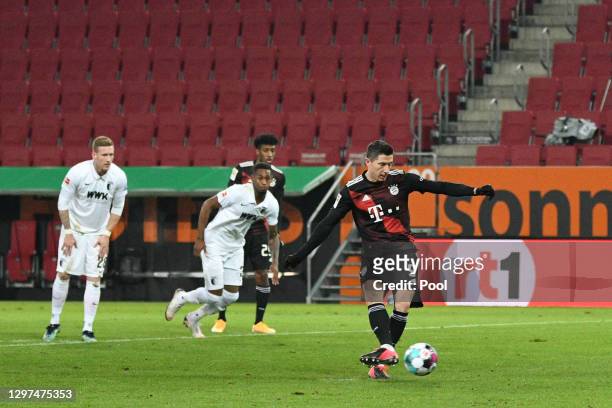 Robert Lewandowski of Bayern Munich scores their team's first goal from the penalty spot during the Bundesliga match between FC Augsburg and FC...