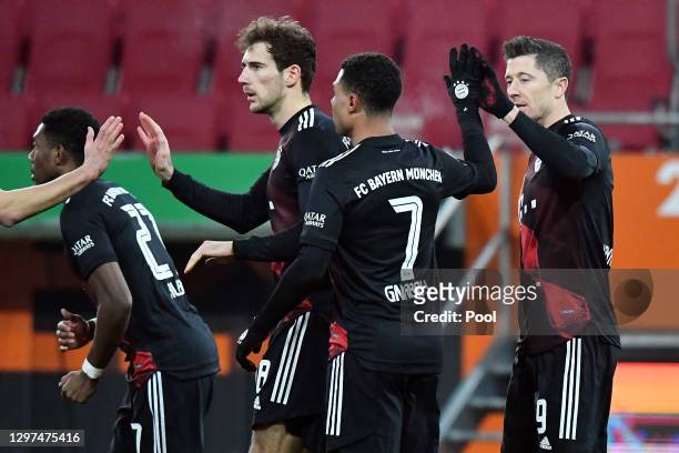 Robert Lewandowski of Bayern Munich celebrates with Serge Gnabre and teammates after scoring their team's first goal during the Bundesliga match...