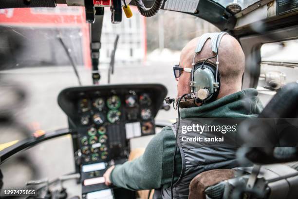 pilot inside a helicopter cockpit. preflight check. - beard pilot stock pictures, royalty-free photos & images