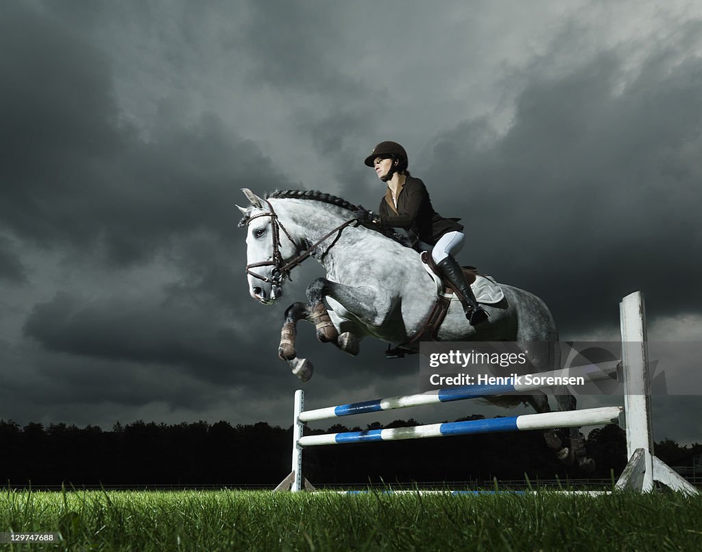 Woman on horse jumping