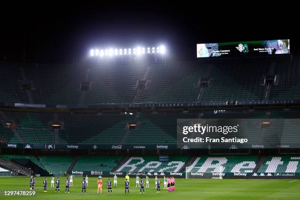 Minutes silence is observed by the players for former Real Betis player Vicente Cantatore and former Real Betis Director Jose Moya Sanabria prior to...