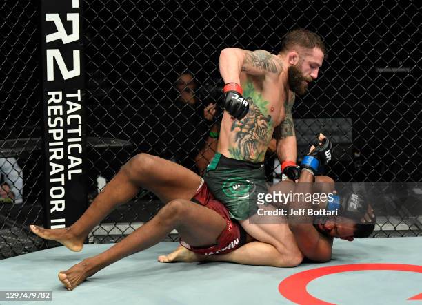 Michael Chiesa punches Neil Magny in a welterweight fight during the UFC Fight Night event at Etihad Arena on UFC Fight Island on January 20, 2021 in...