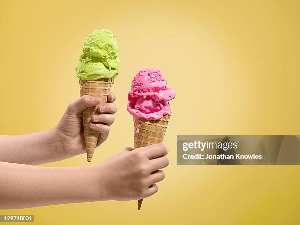 hands holding ice-creams of different flavours. - barquilla de helado fotografías e imágenes de stock