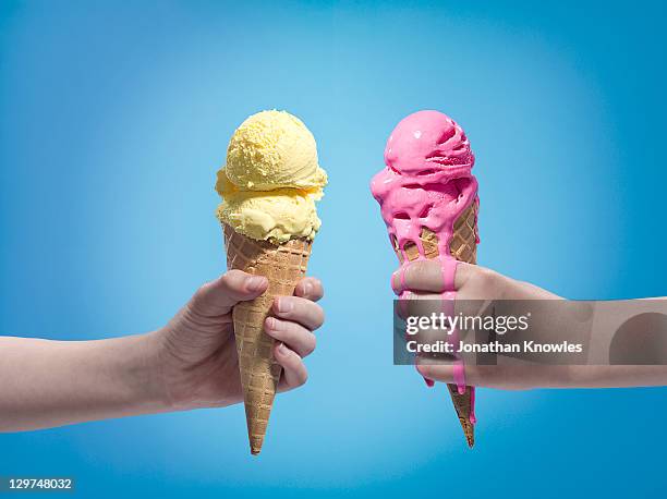 hands holding different flavours ice cream. - icecream cones stock-fotos und bilder