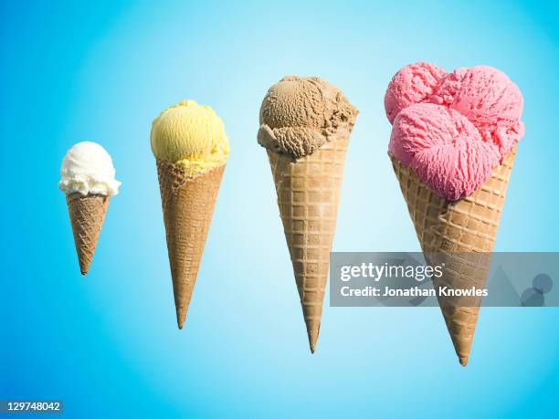 row of different flavor ice creams in growth - barquilla de helado fotografías e imágenes de stock