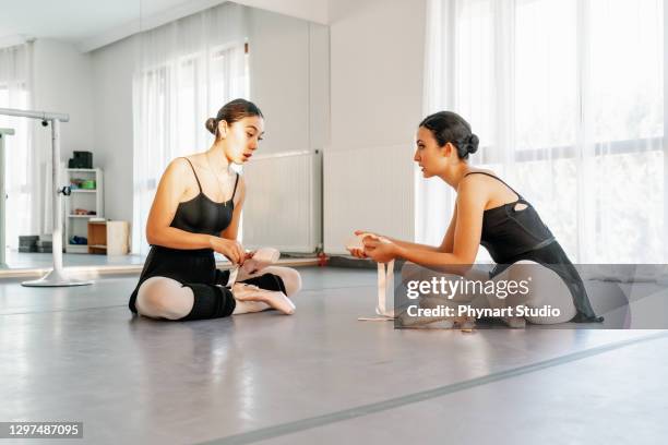 ballerinas chatting after classroom - ballet feet hurt stock pictures, royalty-free photos & images