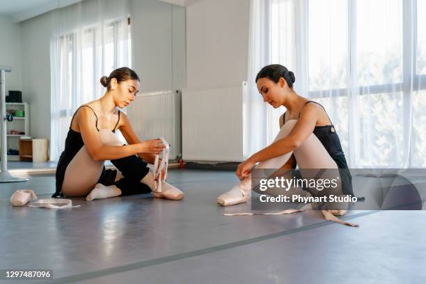 ballerinas chatting after classroom - ballet feet hurt stock pictures, royalty-free photos & images