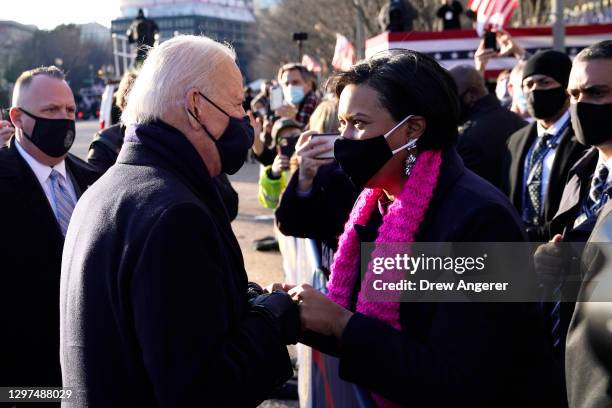 President Joe Biden greets DC Mayor Muriel Bowser on the abbreviated parade route after Biden's inauguration on January 20, 2021 in Washington, DC....