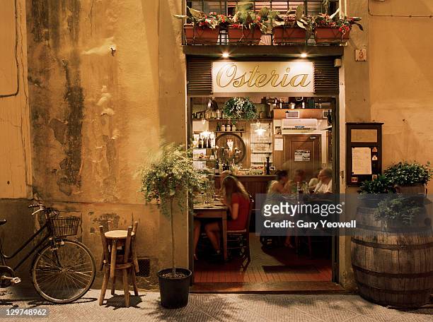 people dining inside an osteria - italien stock-fotos und bilder
