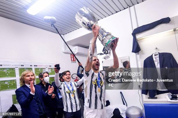 Pavel Nedved vice-president of Juventus, Paulo Dybala and Leonardo Bonucci celebrate with the trophy after winning the Italian PS5 Supercup after...