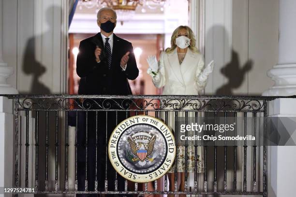 President Joe Biden and first lady Jill Biden watch a fireworks show on the National Mall from the Truman Balcony at the White House January 20, 2021...