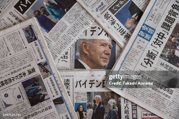 In this photo illustration, reaction to the United States Presidential Inauguration is seen on the front pages of Japanese newspapers on January 21,...