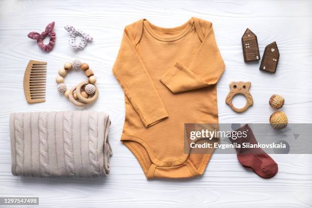 newborn baby clothing, blanket, wooden toys, teether and accessories on white background. - baby clothes stock pictures, royalty-free photos & images