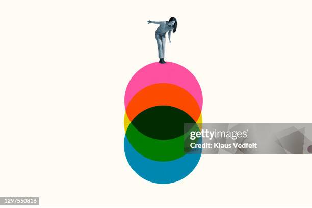 young woman standing on colorful circles - evolution fotografías e imágenes de stock