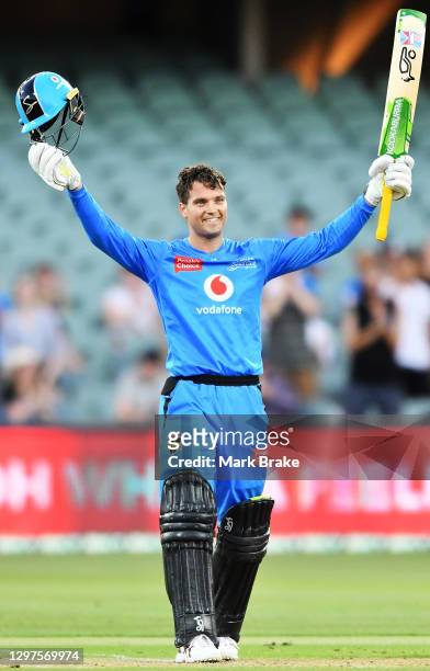 Alex Carey of the Strikers celebrates bringing up his century during the Big Bash League match between the Adelaide Strikers and the Brisbane Heat at...