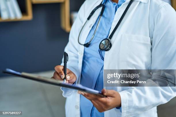 reading over a detailed medical history from her patient - medical document stock pictures, royalty-free photos & images